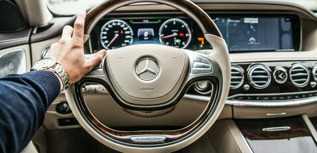 person sitting in Mercedes-Benz driver seat