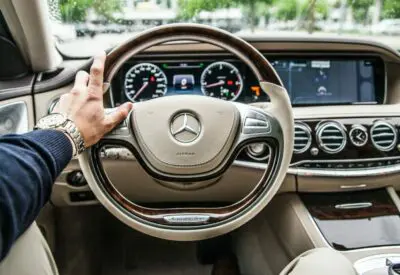 person sitting in Mercedes-Benz driver seat